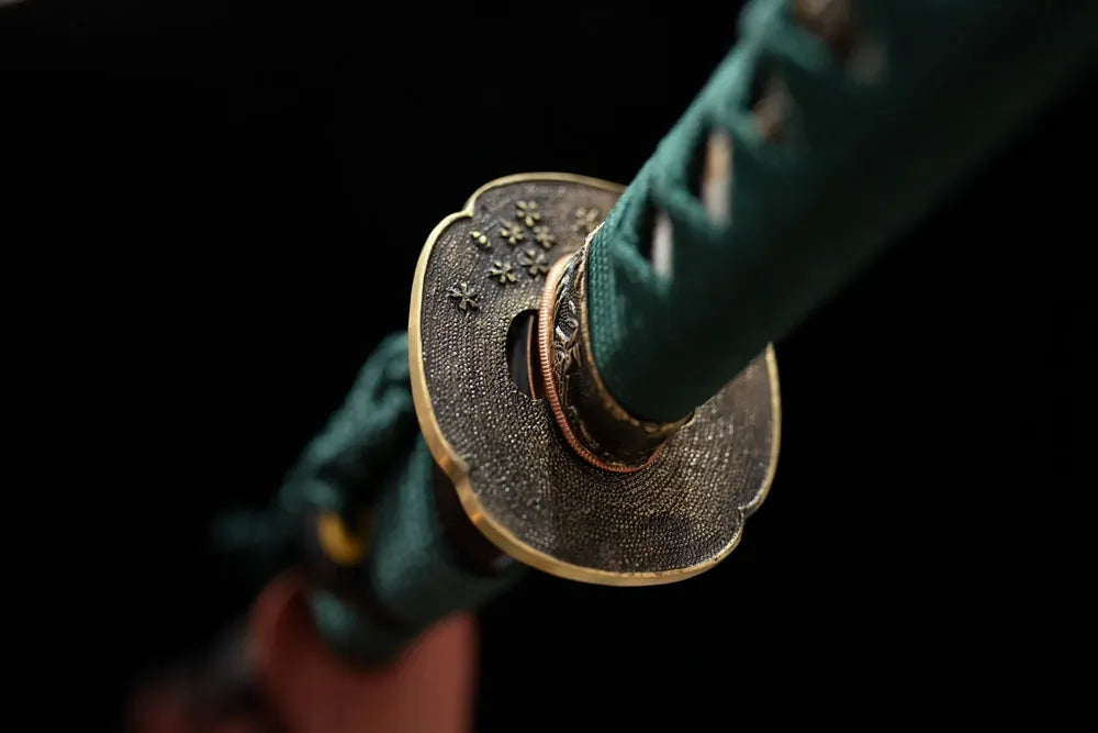 Reverse‑side floral‑beast‑carving vintage‑brass tsuba surface texture close‑up