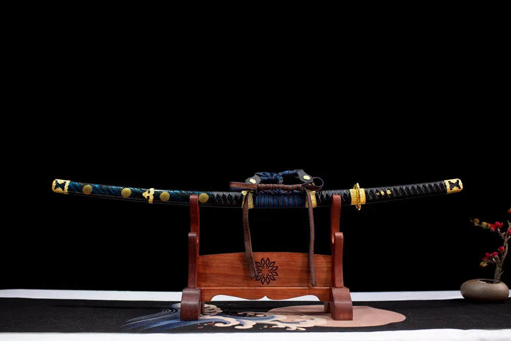 Horizontal laid closed deep‑blue gilded‑mon Imperial‑Family‑Tachi scabbard flat table‑top front display