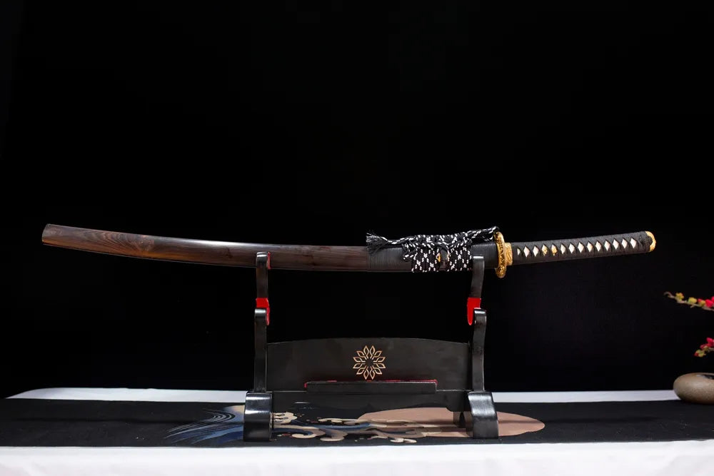 Horizontal laid closed deep‑void‑black star‑orbit‑comet‑tail Comet‑Katana scabbard flat table‑top front display