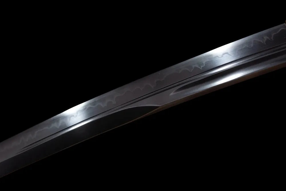 Mid‑section natural wavy‑pattern hamon steel wakizashi blade surface close‑up shot