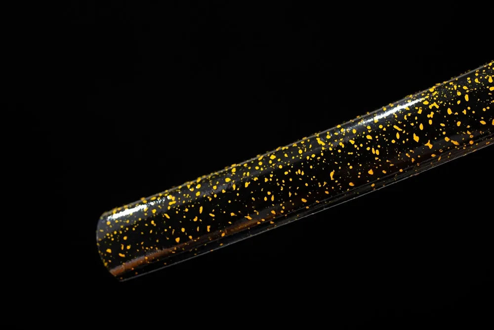 Bottom black saya copper‑brass kojiri end‑cap close‑up