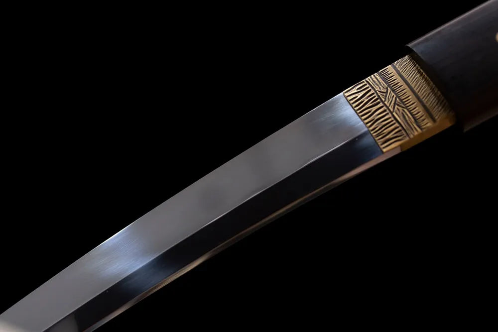Upper T10 clay‑tempered wakizashi blade brass habaki choji wave‑pattern hamon temper‑line macro close‑up