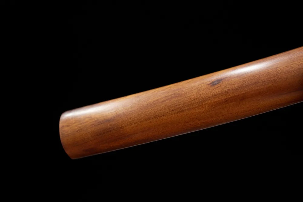 Bottom natural bare‑wood shirasaya saya plain brass‑alloy kojiri end‑cap close‑up