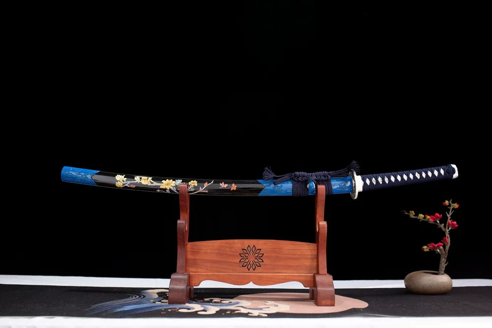 Horizontal laid closed hand‑painted plum‑art Blood‑Plum‑Katana scabbard flat table‑top front display
