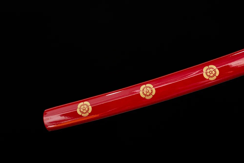 Bottom scarlet‑red saya gold‑plated‑alloy kojiri end‑cap close‑up