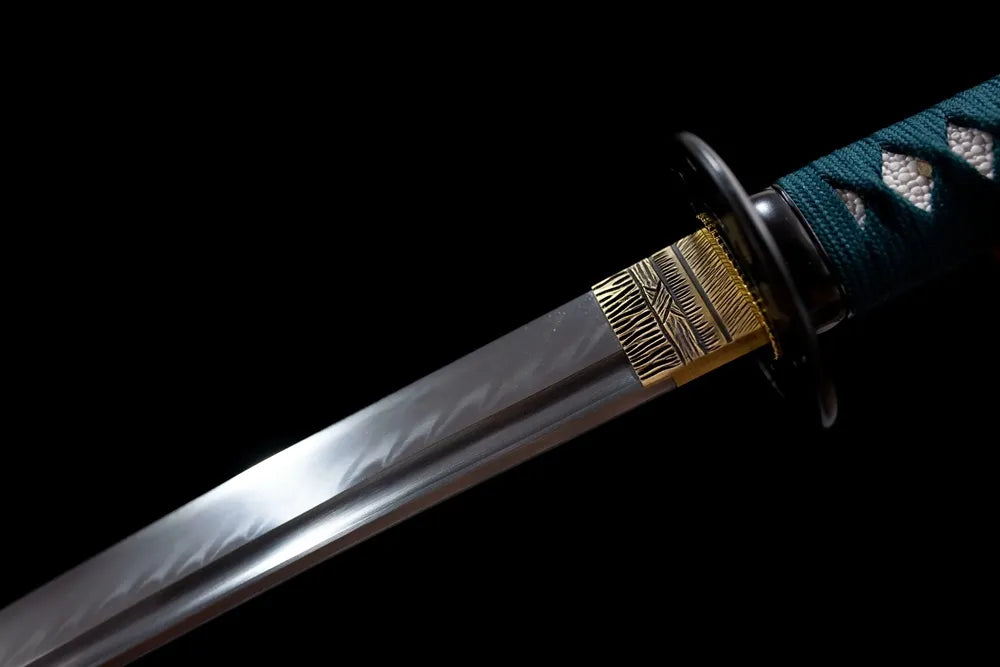Upper polished 1060 steel blade brass‑toned habaki macro close‑up