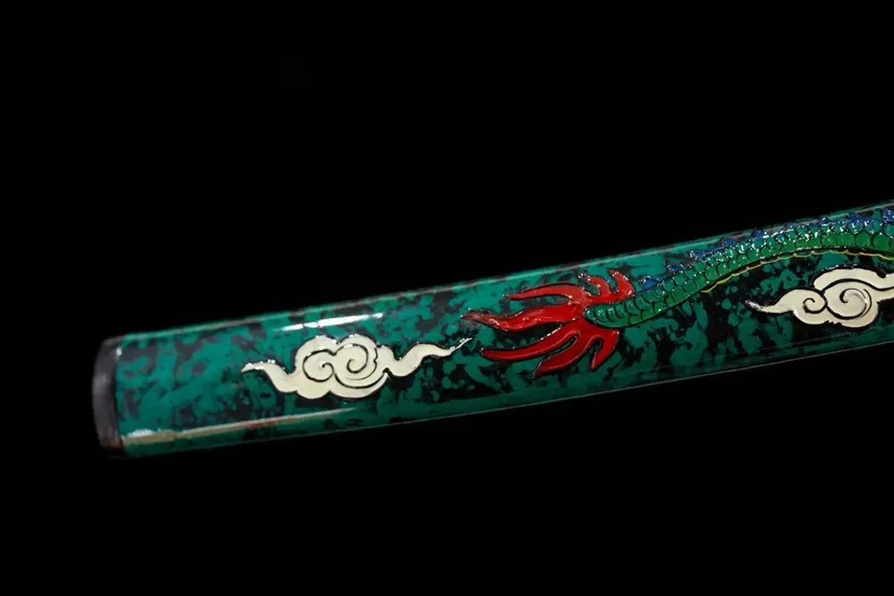 Bottom emerald‑green saya gilded‑alloy kojiri end‑cap close‑up