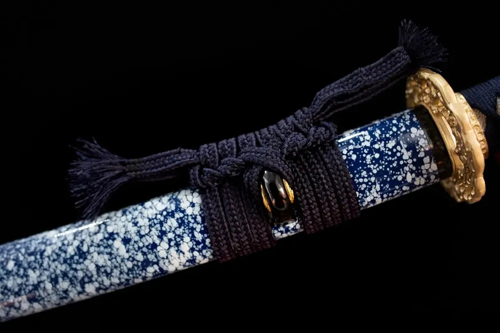 Thin compact navy‑blue braided sageo cord gilded‑copper fitting macro close‑up‑wakizashi