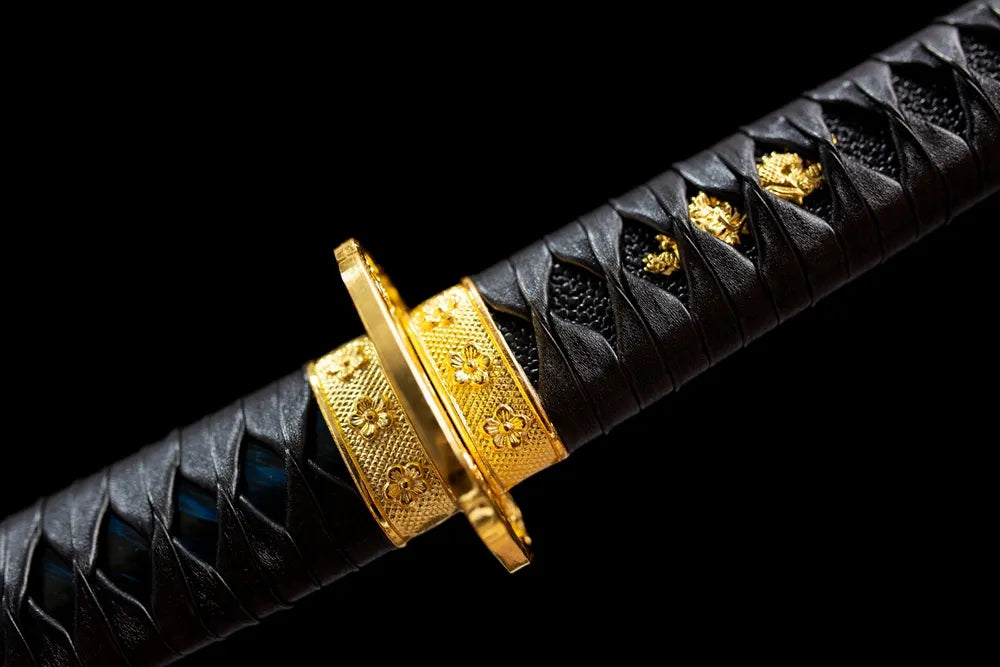 Chrysanthemum‑mon gilded‑brass fuchi grip‑ring macro close‑up