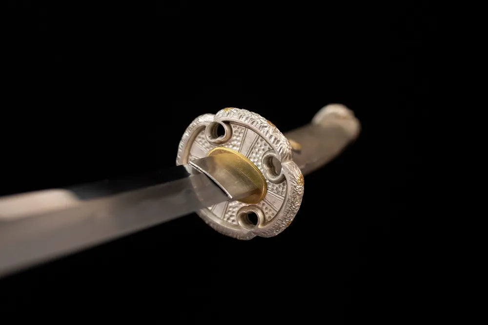 Front open‑work floral‑cluster‑relief silver‑plated copper tachi hand‑guard close‑up