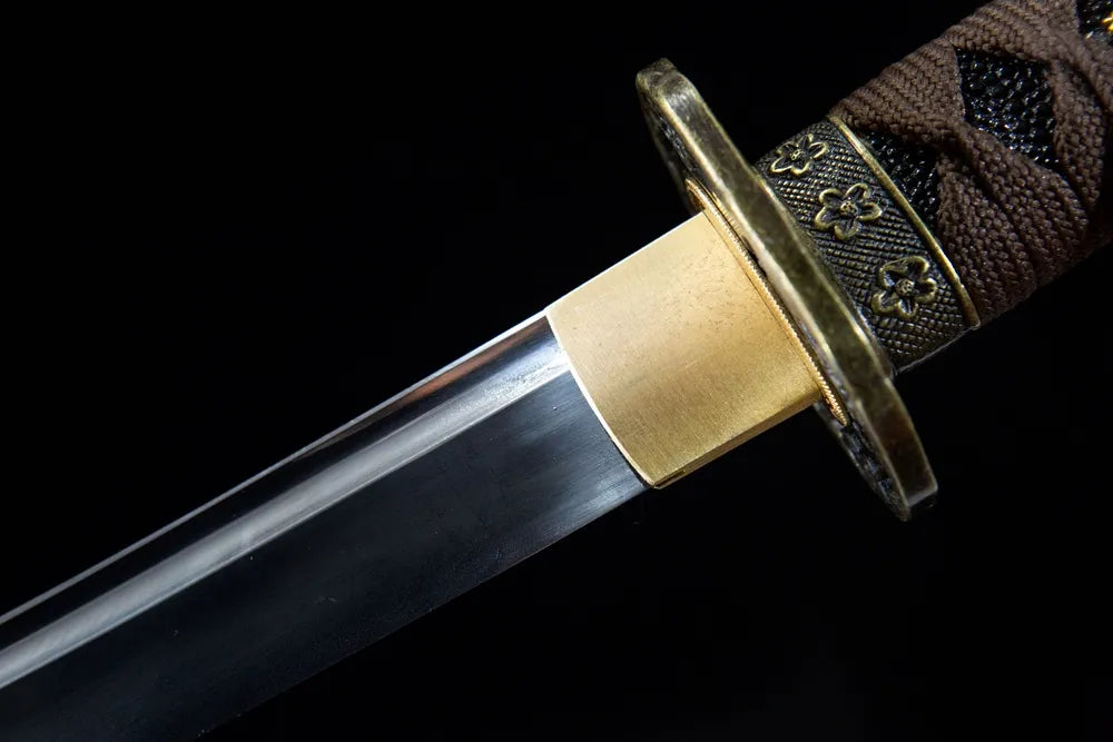 Upper long blade closeup plain polished T10 steel near antique bronze habaki
