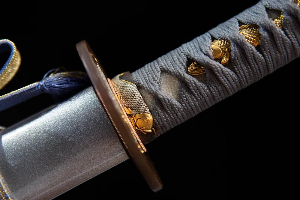 Gilded copper fish grip ring close view