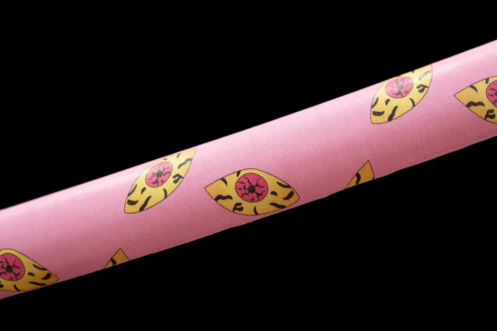 Mid‑section pink hardwood saya yellow demon‑eye print texture close‑up
