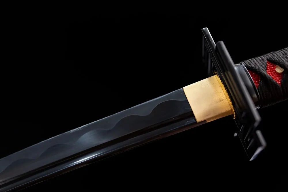 Upper section black‑coated Tensa Zangetsu blade, wave hamon and golden habaki close‑up
