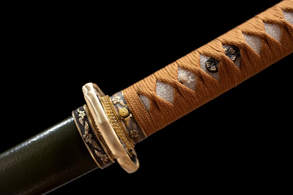 Floral‑ornament aged‑brass military‑spec fuchi grip‑ring macro close‑up