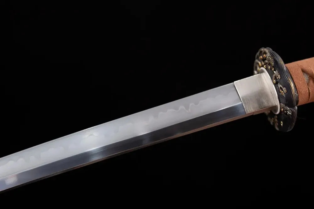 Upper T10 clay‑tempered katana blade brass habaki midare‑choji surging‑ocean‑tide layered‑wave hamon temper‑line macro close‑up