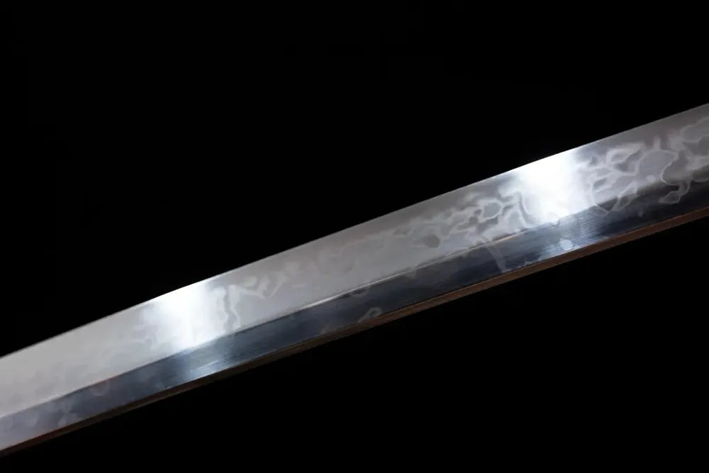 Mid‑section hitatsura flowing‑water‑undulating‑pattern hamon steel katana blade surface close‑up shot