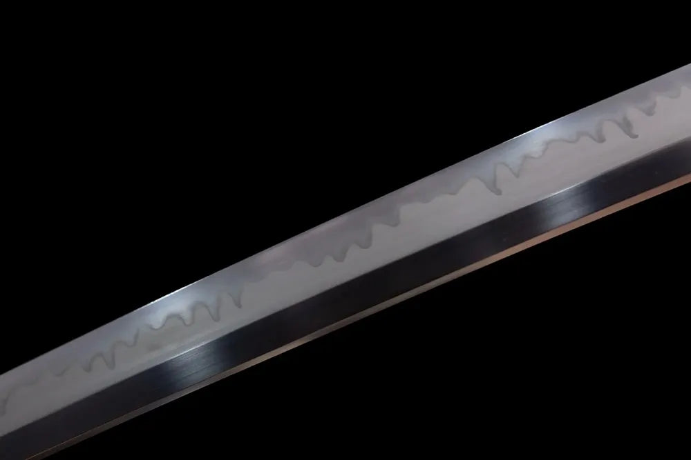 Mid‑section natural hamon wave texture of short wakizashi steel blade close‑up shot
