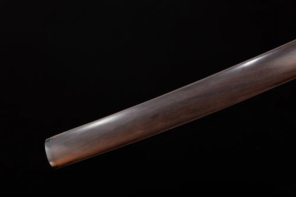 Bottom natural‑matte‑timber saya aged‑copper kojiri end‑cap close‑up