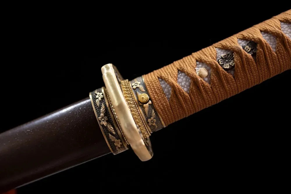 Floral‑engraved military‑spec brass fuchi grip‑ring macro close‑up