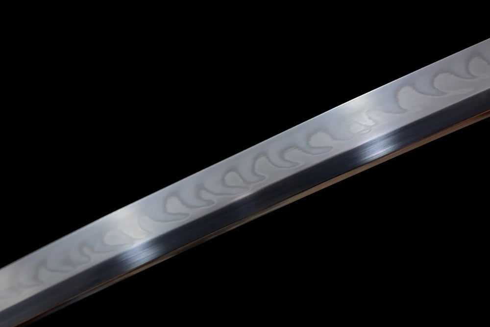 Mid‑section suguha‑gunome blended‑pattern hamon steel katana blade surface close‑up shot
