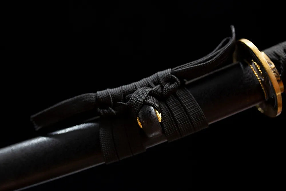 Thick black braided sageo cord brass fitting macro close‑up