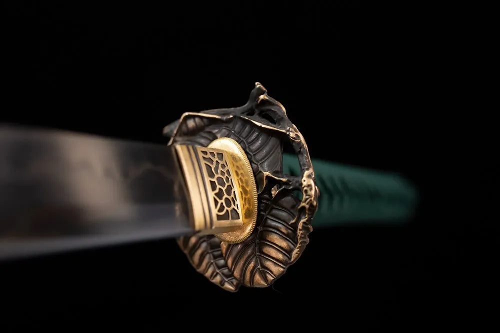 Front open‑work grasshopper‑leaf‑relief aged‑teal‑bronze katana hand‑guard close‑up