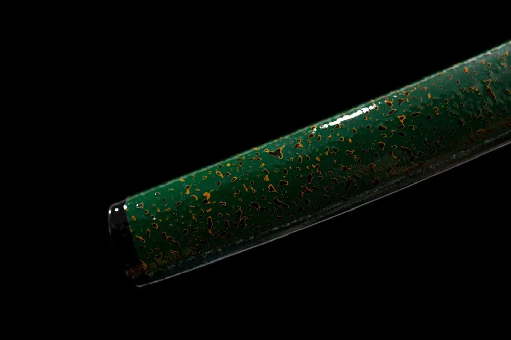 Bottom emerald‑gradient saya brass‑alloy kojiri end‑cap close‑up