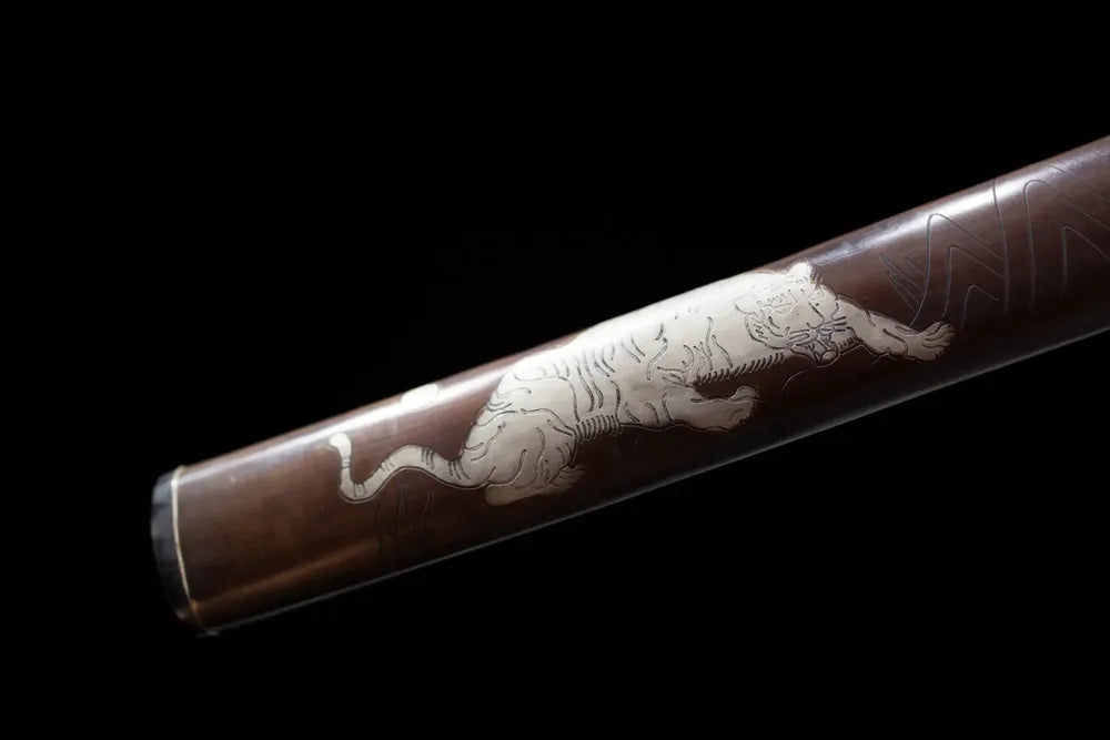 Bottom brown hardwood saya vintage‑brass kojiri end‑cap close‑up