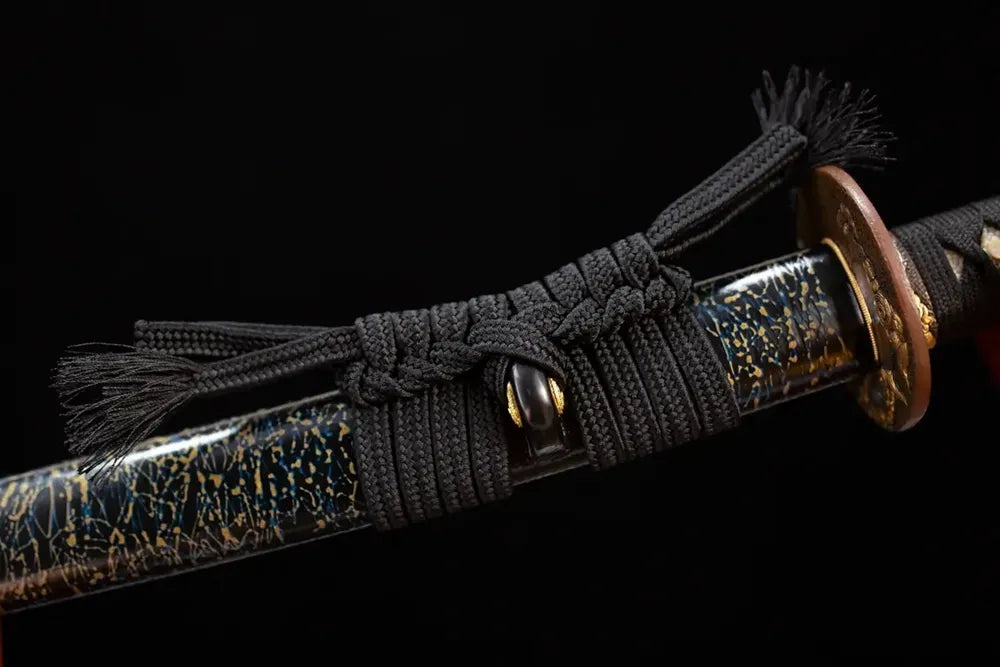 Thick heavy black‑braided sageo cord aged‑bronze‑gilded fitting macro close‑up