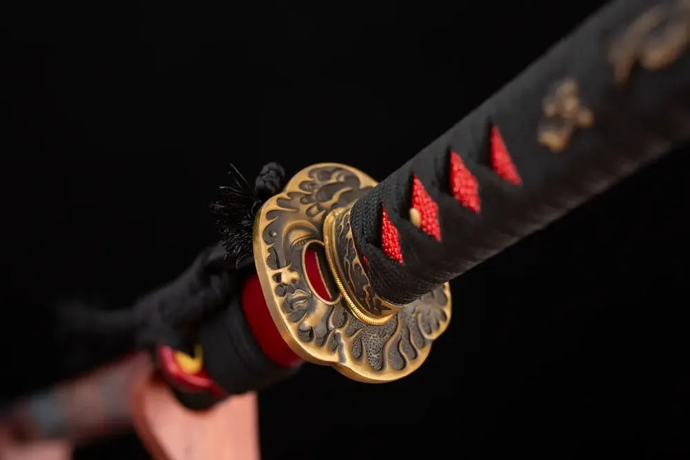 Reverse‑side hannya‑ghost‑scroll carving brass‑gilded tsuba surface texture close‑up