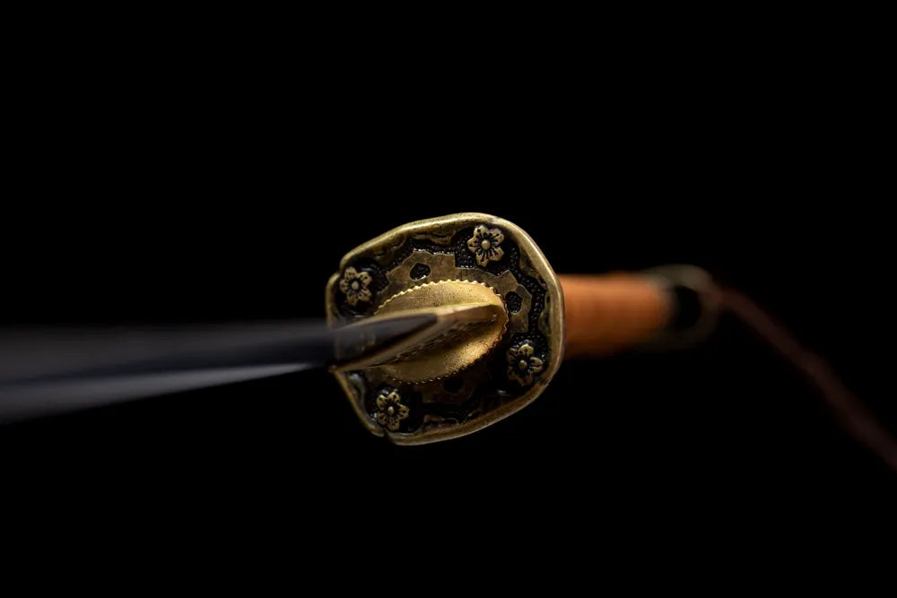 Front floral‑pattern vintage‑brass shin‑gunto officer‑saber hand‑guard close‑up