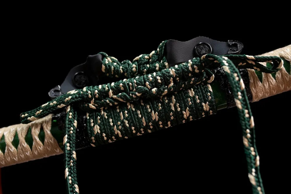 Thick sage‑green‑white mixed braided tachi‑no‑sageo cord zinc‑alloy fitting macro close‑up
