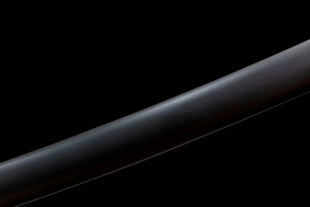 Mid‑section matte‑black solid‑hardwood saya smooth lacquer texture close‑up