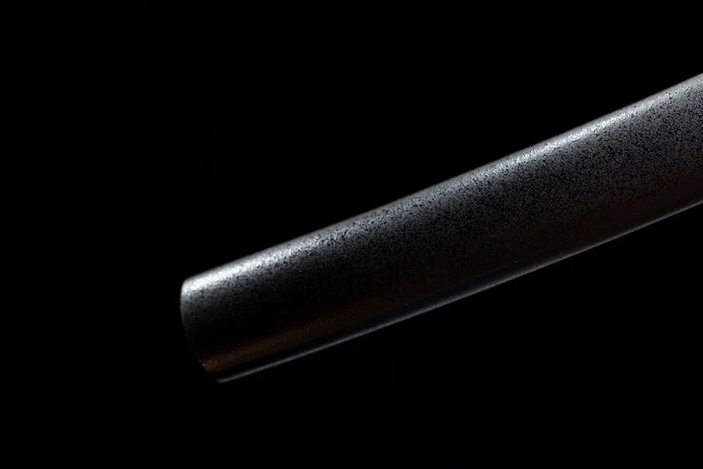 Bottom textured black saya brass alloy end‑cap close‑up