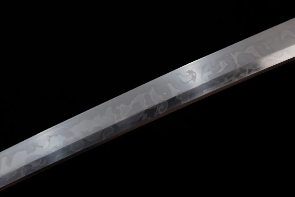Mid‑section choji‑gunome bell‑ripple layered‑serrated‑pattern hamon steel katana blade surface close‑up shot