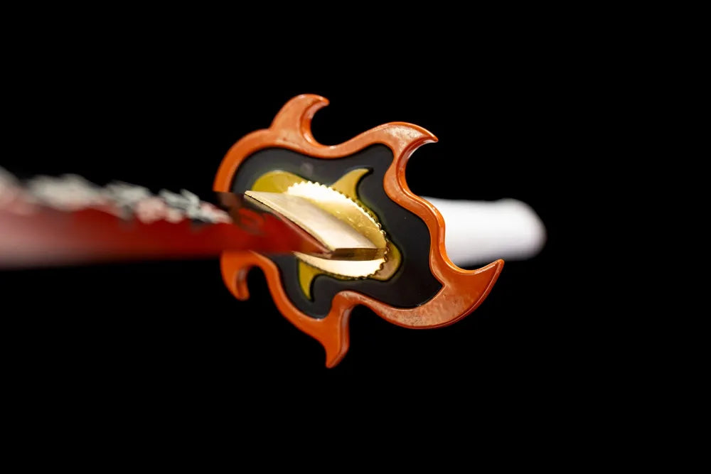 Front iconic hollow flame‑shape orange‑gold demon‑slayer hand‑guard close‑up