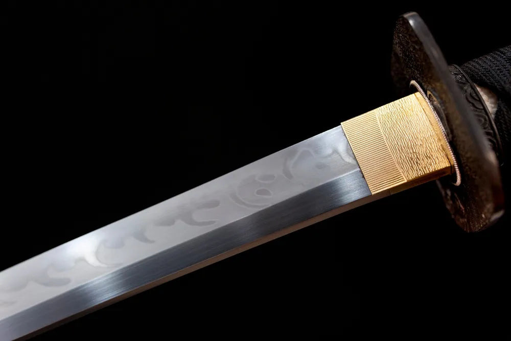 Upper T10 clay‑tempered katana blade brass habaki midare‑gunome surging‑ocean‑wave undulating hamon temper‑line macro close‑up
