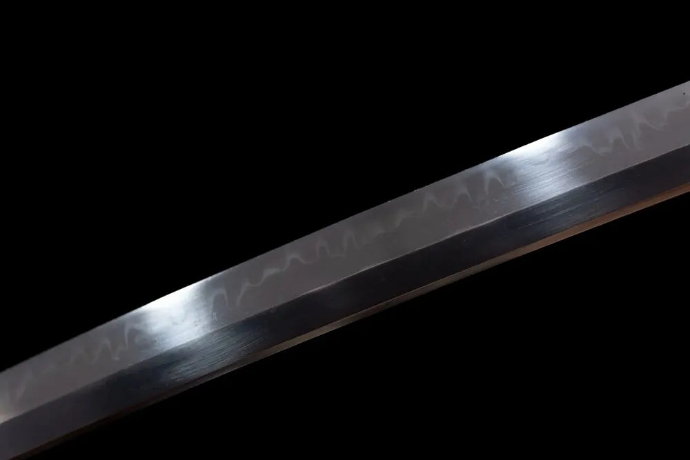 Mid‑section chogi undulating hamon steel tachi blade surface close‑up shot