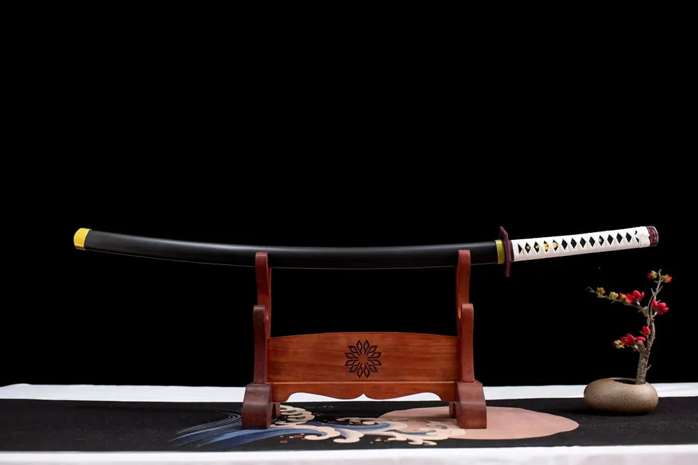 Horizontal laid closed matte‑black Giyuu scabbard flat table‑top front display