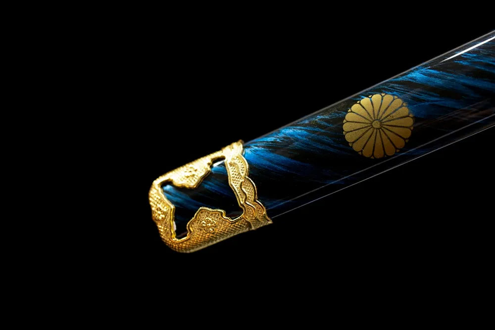 Bottom deep‑blue gilded‑mon saya gilded‑brass kojiri end‑cap close‑up