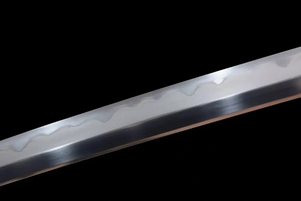 Mid‑section gunome‑pattern hamon composite steel blade surface texture shot