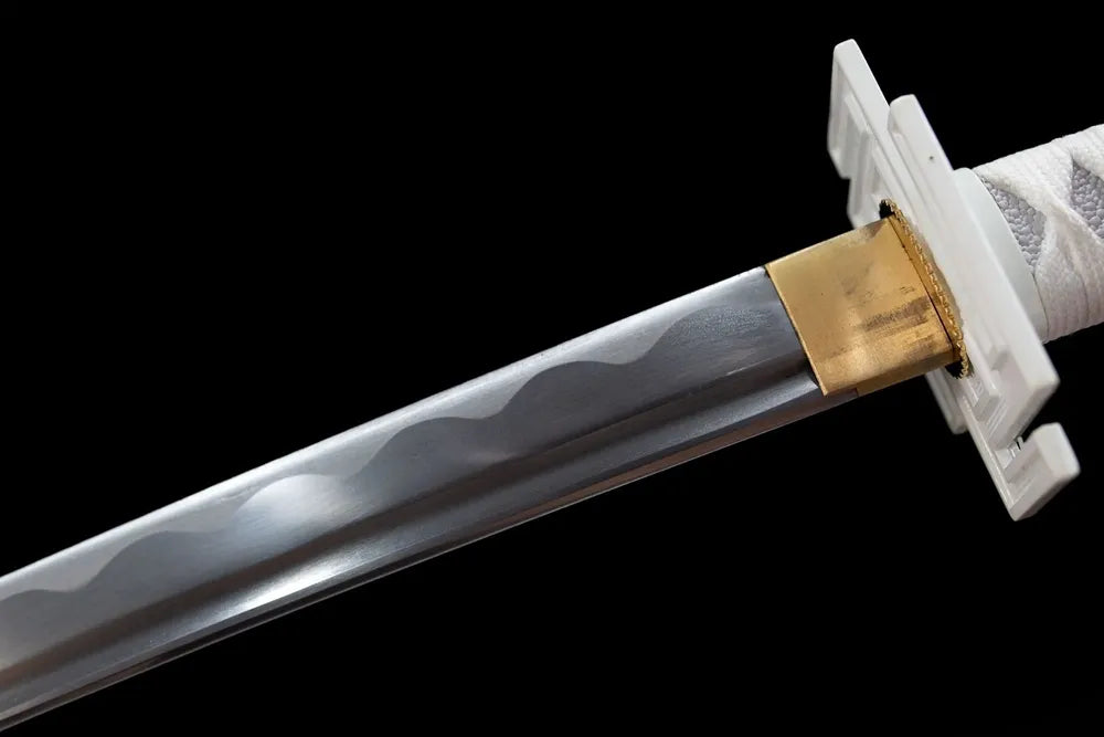 Upper blade segment white‑finish Tensa Zangetsu, temper pattern and metal collar macro shot