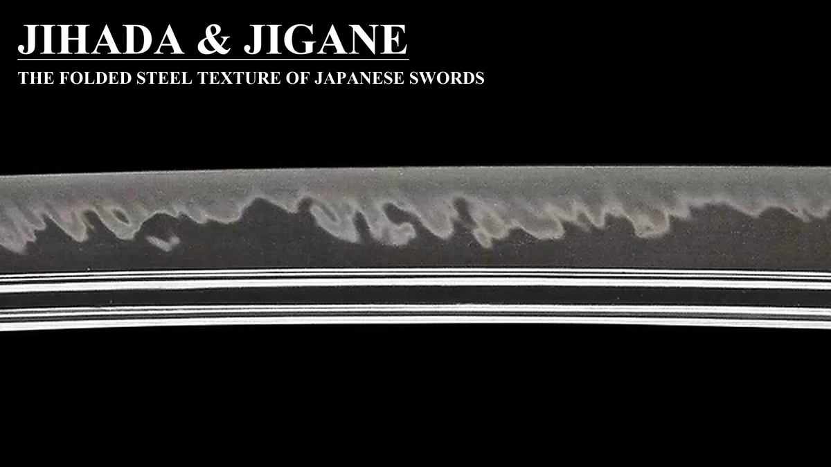 Japanese katana blade with jihada and jigane labels showing folded steel grain pattern on black background
