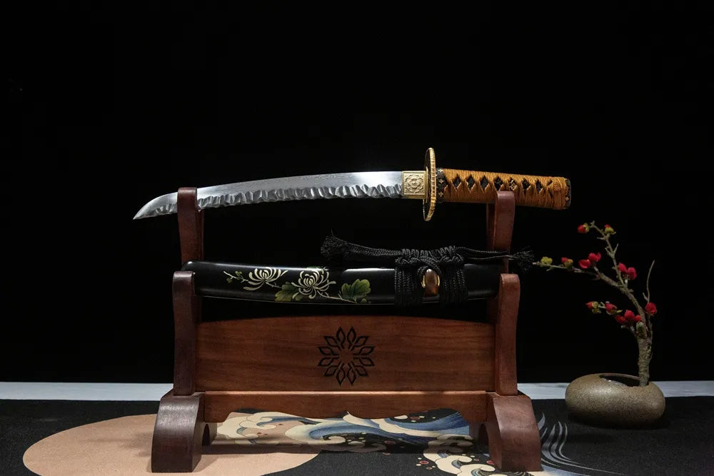 Unsheathed chrysanthemum wakizashi horizontal shot water quenched folded steel maru blade