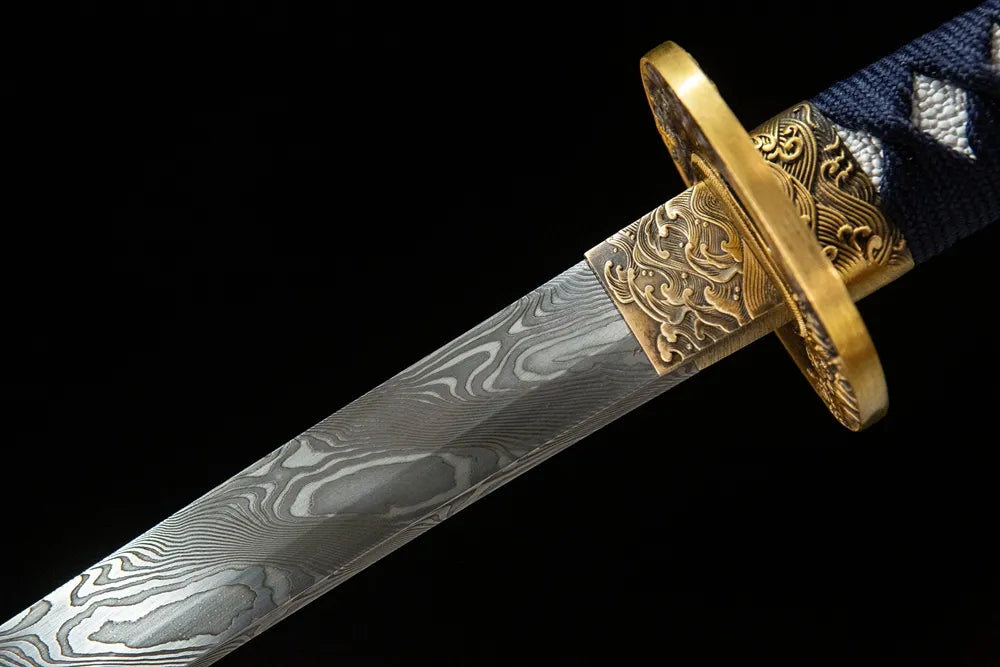 Upper blade closeup twist forge damascus grain near solid copper habaki