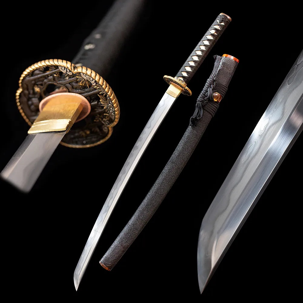 Black‑Knight‑Wakizashi black‑knight samurai‑backup‑side‑arm‑motif japanese wakizashi short sword drawn sanmai damascus‑clad‑T10 gunomu wavy hamon blade solid‑wood wrapped‑real‑fish‑skin saya full black‑background studio shot