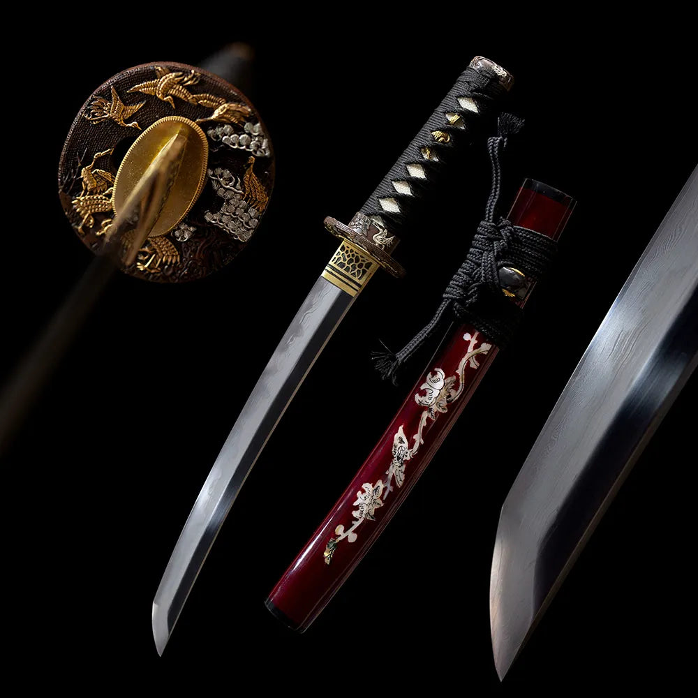 Tsurumaru‑Wakizashi classical‑elegant tsurumaru crane‑crest wakizashi short samurai sword drawn T10 suji‑gunome hamon blade off‑white gold‑crane‑maki‑e saya full black‑background studio shot