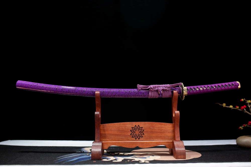 Horizontal laid closed violet‑halo pearlescent maki‑e Lady‑Murasaki‑Katana scabbard flat table‑top front display