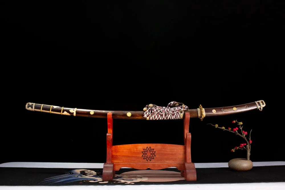 Horizontal laid closed wine‑red imperial‑chrysanthemum maki‑e Royal‑Chrysanthemum‑Tachi scabbard flat table‑top front display